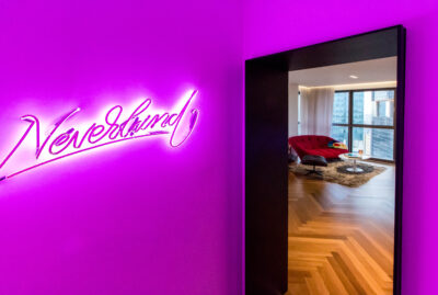 Entrance to the apartment A sign with a purple neon sign Nerverland