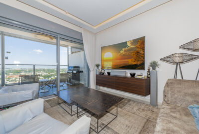 Architectural living room with screen, speakers and balcony view